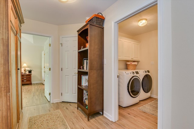 267 Fairway Dr, Mccormick, SC 29835 - laundry area with washing machine and dryer, light wood-type flooring, baseboards, and cabinet space