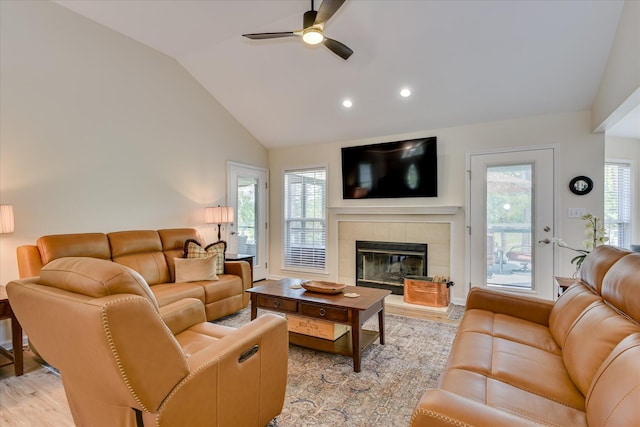 267 Fairway Dr, Mccormick, SC 29835 - living room featuring lofted ceiling, a ceiling fan, a fireplace, light wood-type flooring, and healthy amount of natural light