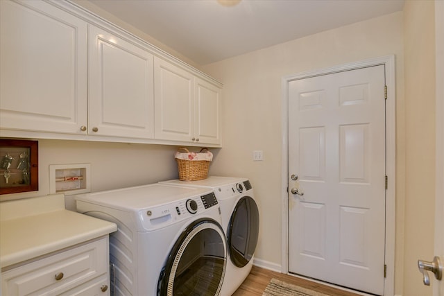 267 Fairway Dr, Mccormick, SC 29835 - laundry area featuring cabinet space, washing machine and clothes dryer, light wood-style floors, and baseboards