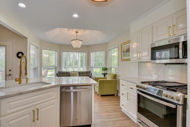 267 Fairway Dr, Mccormick, SC 29835 - kitchen with stainless steel appliances, a sink, light wood-style flooring, white cabinets, and recessed lighting