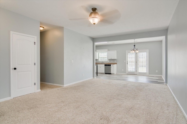 4909 Ashbrooke Way, Grovetown, GA 30813 - unfurnished living room featuring light carpet, a ceiling fan, and a chandelier