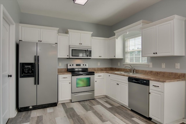 4909 Ashbrooke Way, Grovetown, GA 30813 - kitchen featuring appliances with stainless steel finishes, light wood finished floors, and white cabinetry