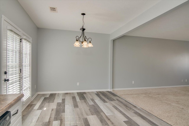 4909 Ashbrooke Way, Grovetown, GA 30813 - unfurnished dining area featuring plenty of natural light, a chandelier, and light wood-style floors