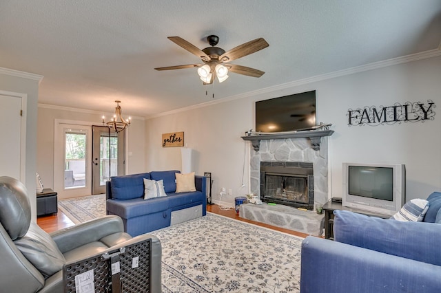 1414 Brookgreen Dr, North Augusta, SC 29841 - living area featuring ornamental molding, wood finished floors, a chandelier, a ceiling fan, and a stone fireplace