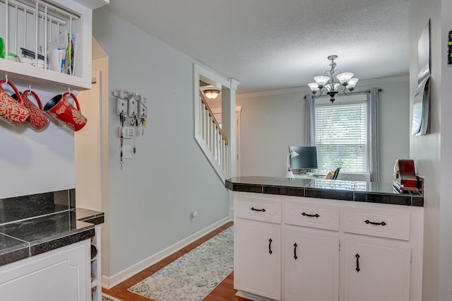 1414 Brookgreen Dr, North Augusta, SC 29841 - kitchen featuring white cabinets, dark wood-style flooring, tile countertops, a chandelier, and a peninsula