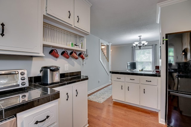 1414 Brookgreen Dr, North Augusta, SC 29841 - kitchen featuring freestanding refrigerator, light wood finished floors, white cabinets, a chandelier, and a peninsula