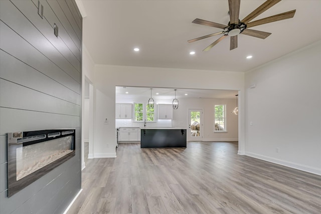 109 Dogwood Trl, Hephzibah, GA 30815 - living area with a glass covered fireplace, recessed lighting, crown molding, light wood-style floors, and baseboards
