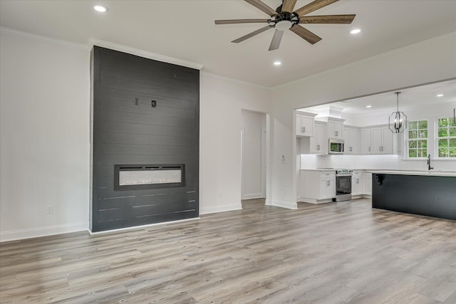 109 Dogwood Trl, Hephzibah, GA 30815 - unfurnished living room featuring a ceiling fan, a fireplace, recessed lighting, ornamental molding, and light wood finished floors
