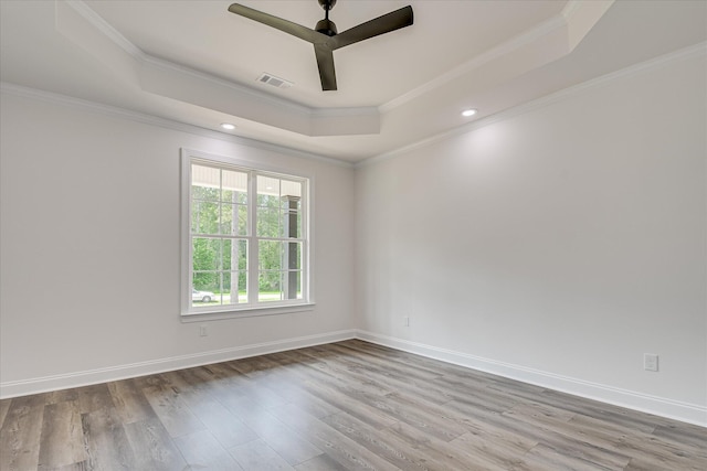 109 Dogwood Trl, Hephzibah, GA 30815 - unfurnished room with a tray ceiling, wood finished floors, a ceiling fan, crown molding, and baseboards