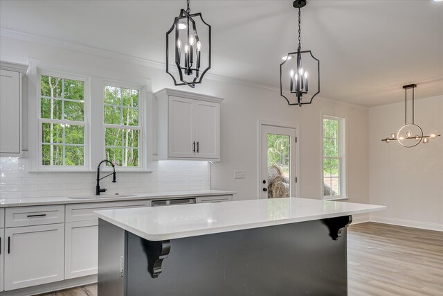 109 Dogwood Trl, Hephzibah, GA 30815 - kitchen featuring a sink, a chandelier, backsplash, and ornamental molding