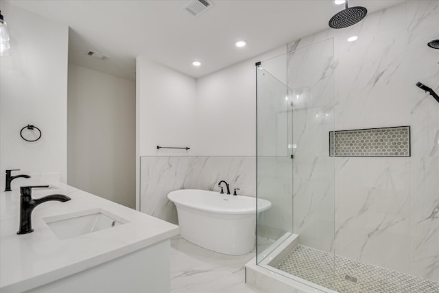 109 Dogwood Trl, Hephzibah, GA 30815 - bathroom with marble tiled floors, a marble finish shower, a freestanding bath, tile walls, and recessed lighting