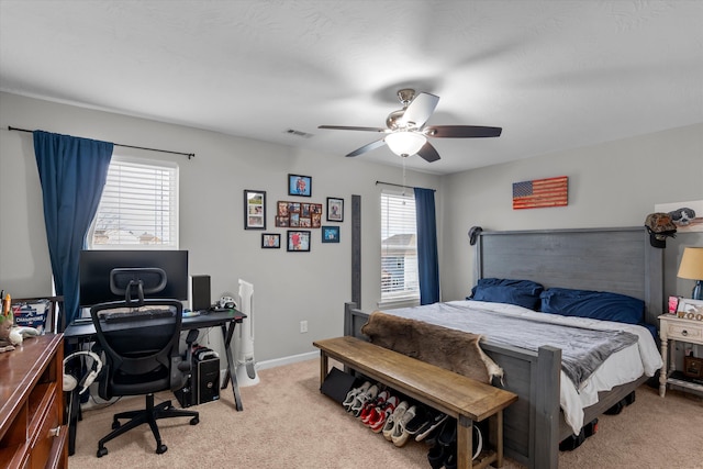 bedroom featuring light carpet, ceiling fan, visible vents, and baseboards