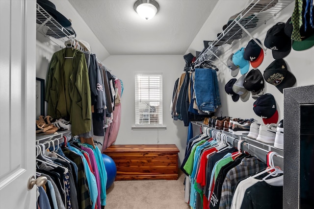 spacious closet featuring light carpet and vaulted ceiling