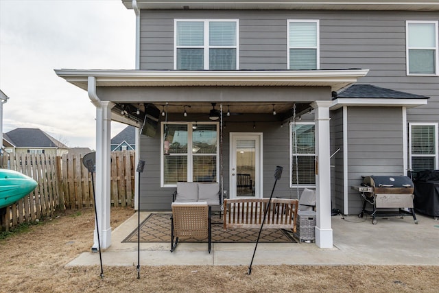 back of property with ceiling fan, outdoor lounge area, a patio area, and a fenced backyard