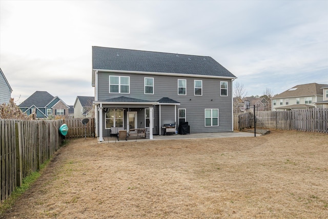 rear view of house with a patio area, a fenced backyard, a residential view, and a lawn