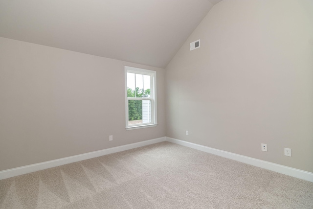 2421 Laurens St, Grovetown, GA 30813 - empty room featuring light carpet, lofted ceiling, and baseboards