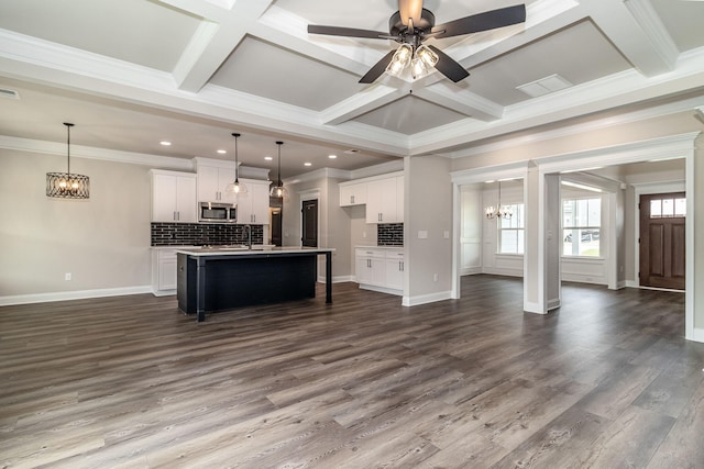 2421 Laurens St, Grovetown, GA 30813 - kitchen featuring stainless steel microwave, a chandelier, open floor plan, coffered ceiling, and backsplash