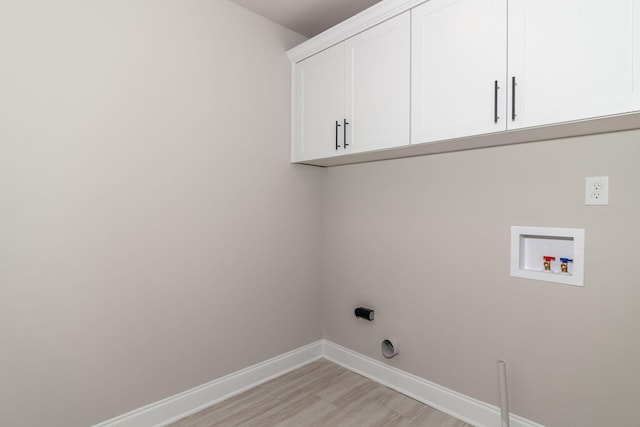 2421 Laurens St, Grovetown, GA 30813 - laundry room featuring cabinet space, baseboards, washer hookup, and light wood-style flooring