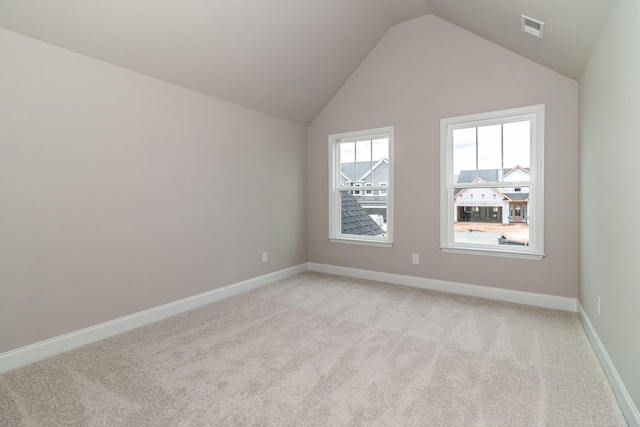 2421 Laurens St, Grovetown, GA 30813 - empty room with light carpet, vaulted ceiling, and baseboards