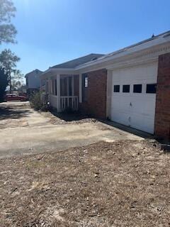 2838 Pepperdine Dr, Hephzibah, GA 30815 - view of property exterior featuring a garage, dirt driveway, and brick siding
