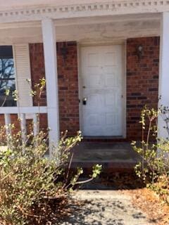 entrance to property with brick siding