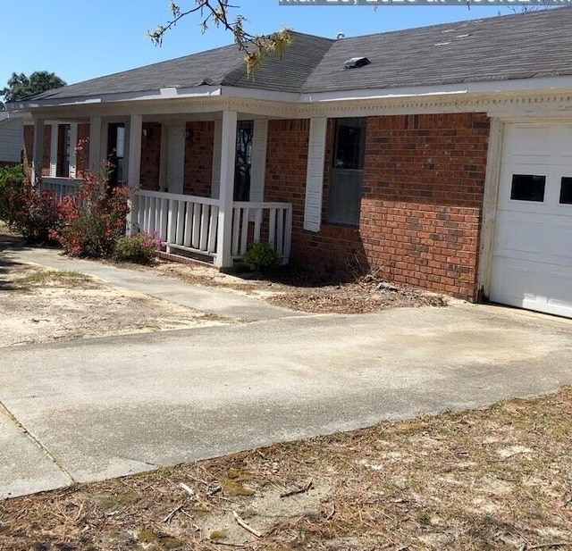 2838 Pepperdine Dr, Hephzibah, GA 30815 - exterior space with covered porch, roof with shingles, brick siding, concrete driveway, and an attached garage