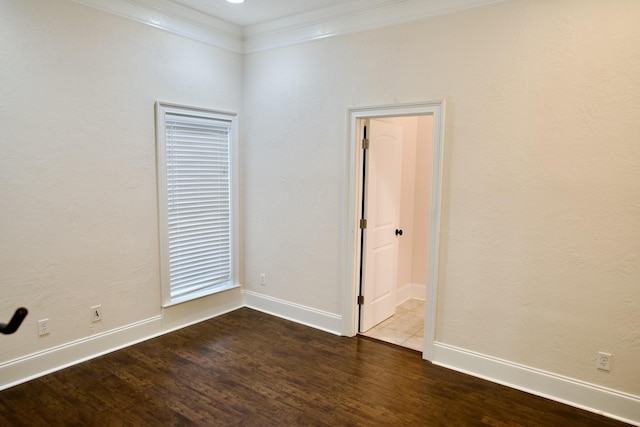 empty room featuring crown molding and hardwood / wood-style floors