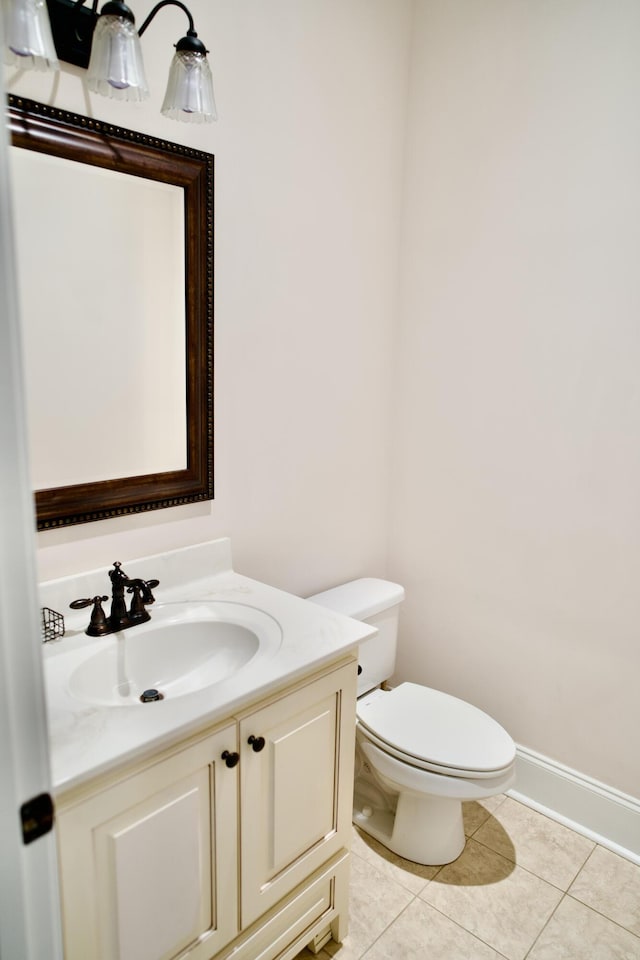 bathroom featuring tile patterned floors, vanity, and toilet