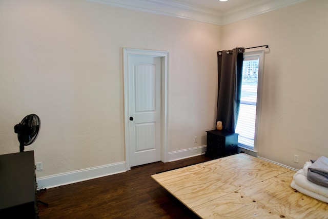 bedroom with dark hardwood / wood-style flooring and ornamental molding