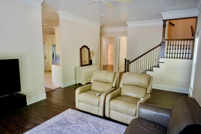 living room with dark hardwood / wood-style flooring, ceiling fan, and ornamental molding