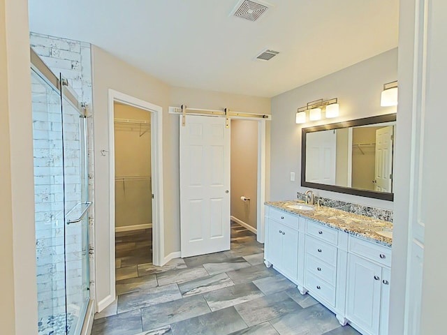 366 Sandleton Way, Evans, GA 30809 - full bathroom with a shower stall, double vanity, a walk in closet, and baseboards