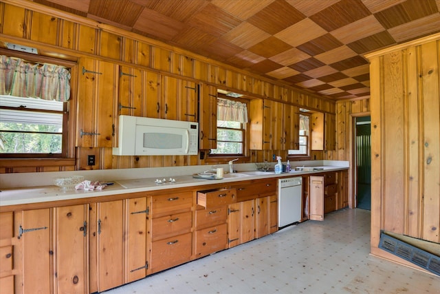 2910-2920 Milledgeville Rd, Augusta, GA 30904 - kitchen with white appliances, wood walls, light countertops, light floors, and brown cabinets