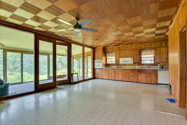 2910-2920 Milledgeville Rd, Augusta, GA 30904 - kitchen featuring white appliances, healthy amount of natural light, light flooring, and wooden walls