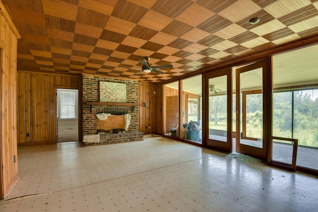 2910-2920 Milledgeville Rd, Augusta, GA 30904 - unfurnished living room with wood walls, ceiling fan, a brick fireplace, and tile patterned floors
