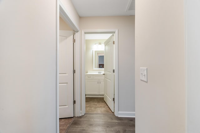 hall with dark hardwood / wood-style flooring and sink