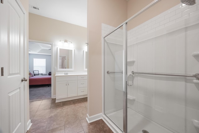 bathroom featuring vanity, tile patterned flooring, and a shower with shower door