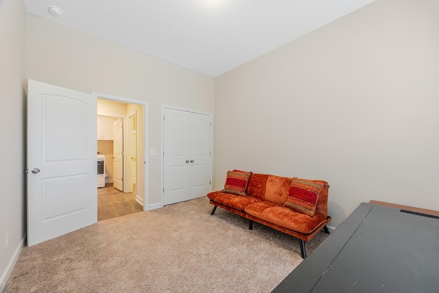 sitting room featuring light carpet