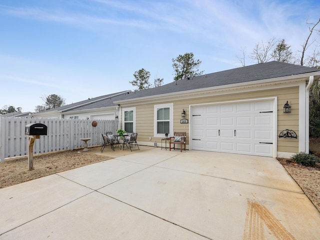 ranch-style home featuring a garage and a patio area