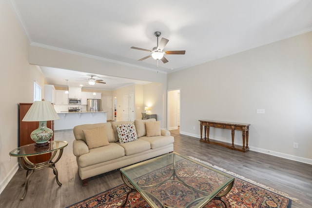 living room with crown molding, dark hardwood / wood-style floors, and ceiling fan