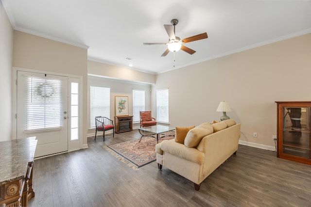 living room featuring dark hardwood / wood-style flooring, crown molding, and ceiling fan