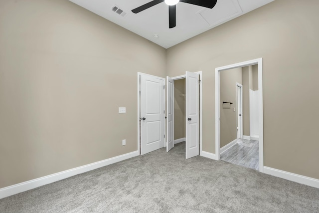 unfurnished bedroom with ceiling fan and light colored carpet