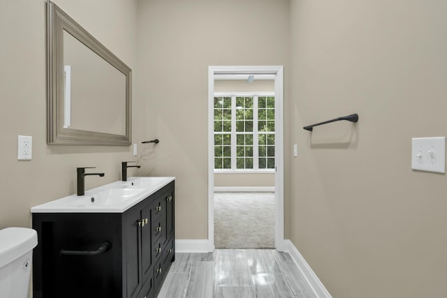 bathroom featuring vanity and toilet