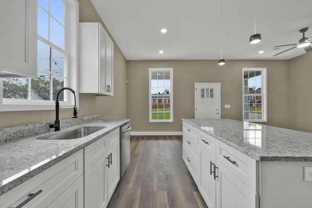 kitchen with white cabinetry, sink, dishwasher, ceiling fan, and pendant lighting