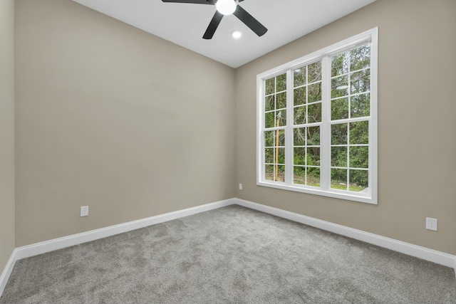 carpeted spare room with ceiling fan