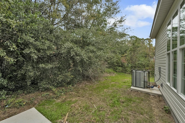 view of yard featuring central air condition unit