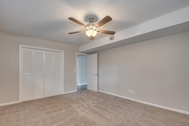 unfurnished bedroom with carpet flooring, ceiling fan, and a closet