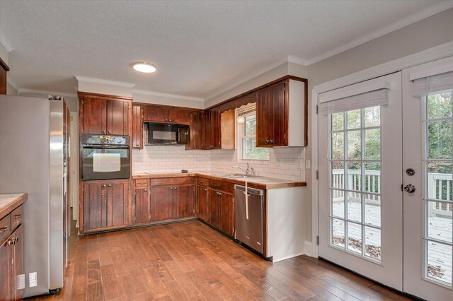 kitchen featuring sink, french doors, tasteful backsplash, light hardwood / wood-style floors, and black appliances