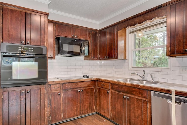 kitchen featuring sink, light hardwood / wood-style floors, a textured ceiling, decorative backsplash, and black appliances