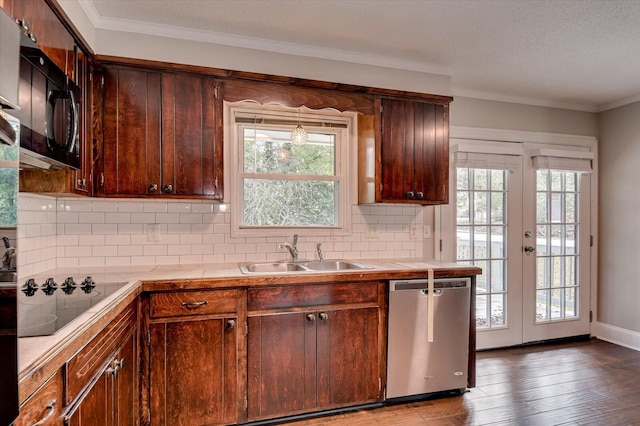 kitchen featuring french doors, tasteful backsplash, sink, black appliances, and hardwood / wood-style floors