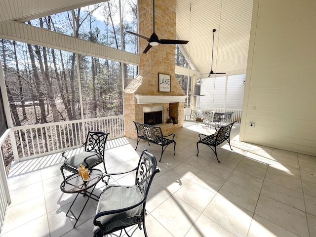 exterior space with ceiling fan and an outdoor stone fireplace